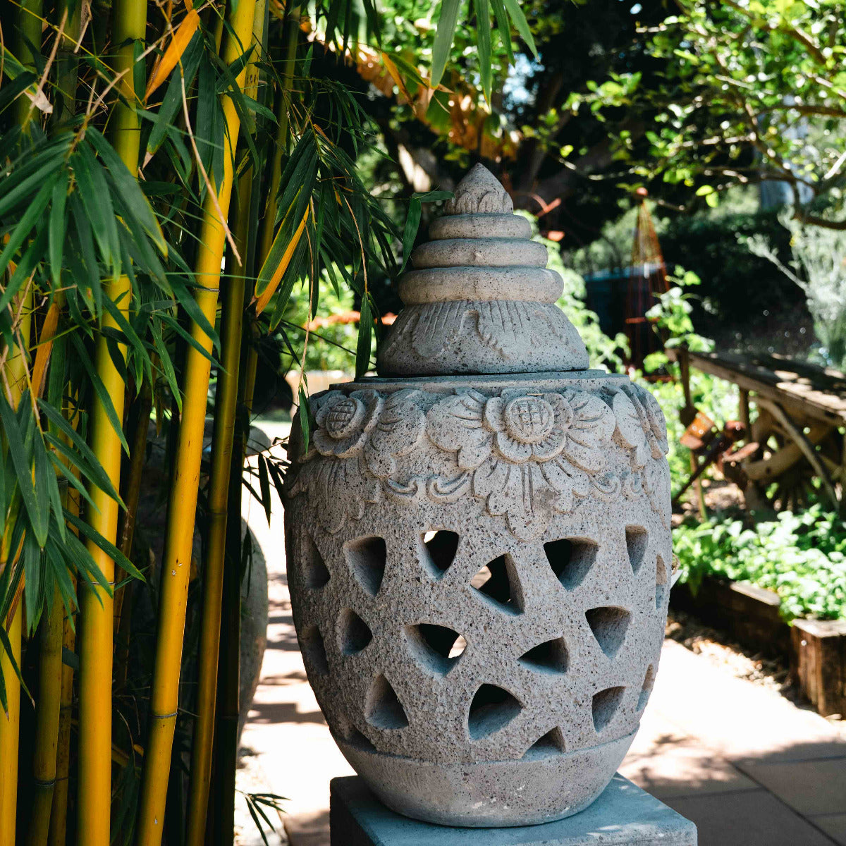 Decorative stone lantern with bamboo plants in a garden setting