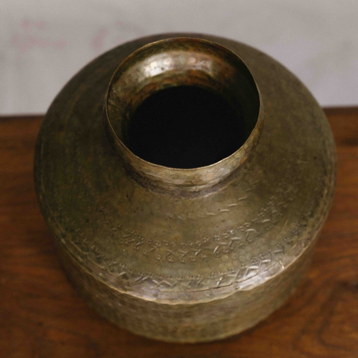 Vintage Indian brass mini vase, 22cm, featuring a rounded body, narrow neck, hammered detailing and aged golden patina, exclusive to Brookfield Gardens.