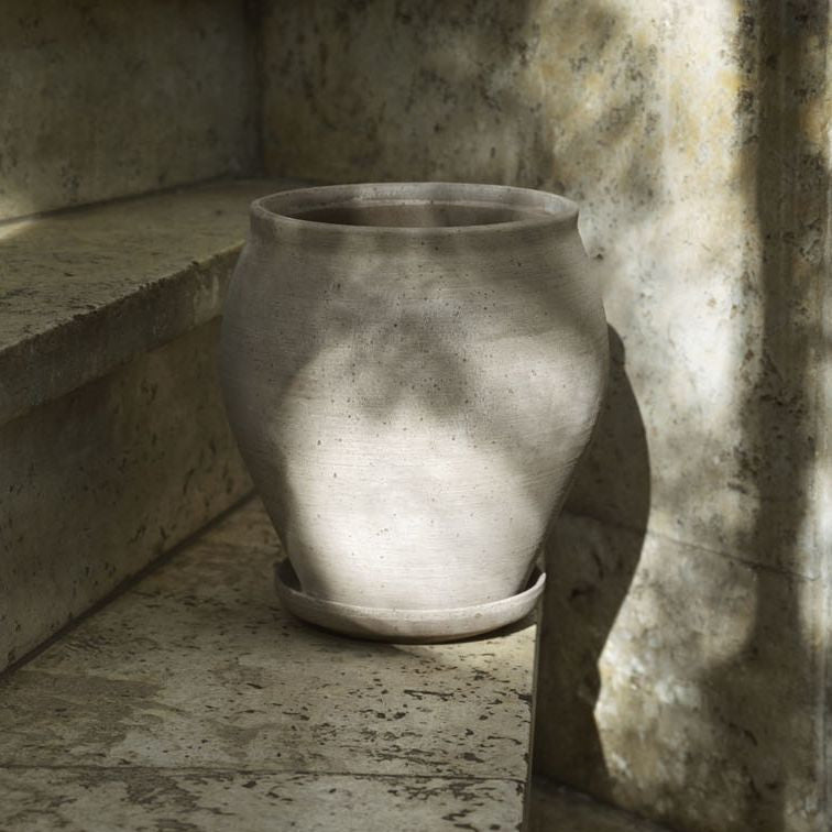 Bergs Potter Delphi Grey Tall terracotta planter with matching saucer in grey finish.