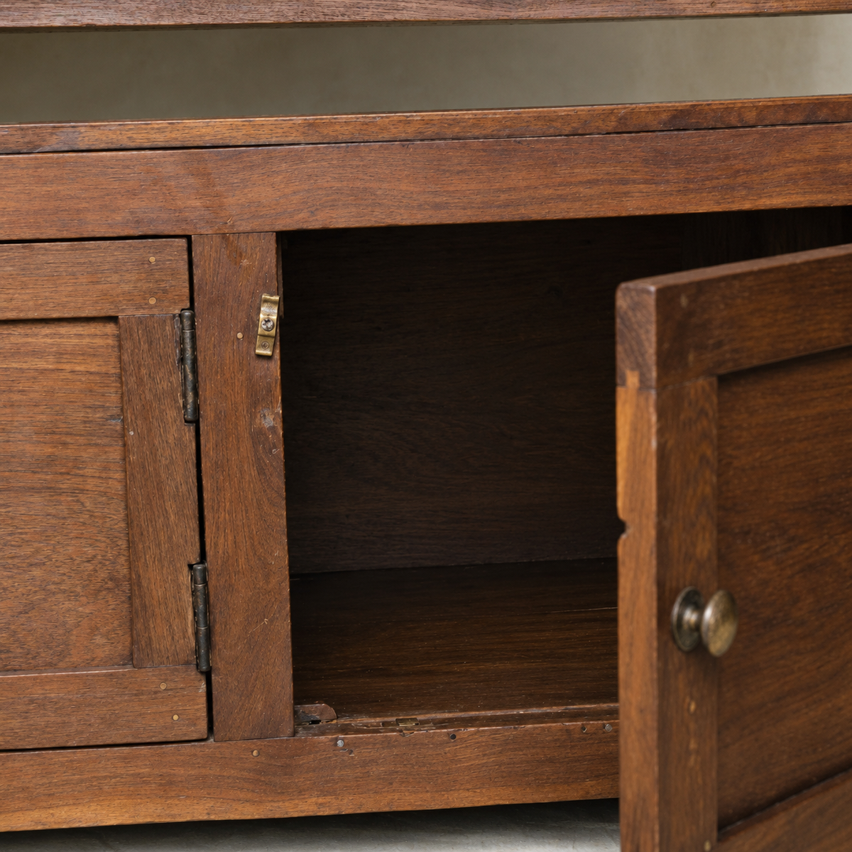 Vintage Indian wooden bench with three-door storage cupboard and naturally aged timber finish, exclusive to Brookfield Gardens Brisbane.