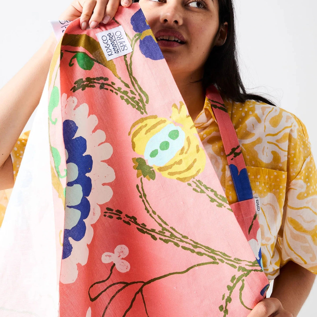 Kip & Co x Anna Spiro Isabelle Sunset Tea Towel featuring oversized blue, aqua, white and yellow florals on a coral pink background.