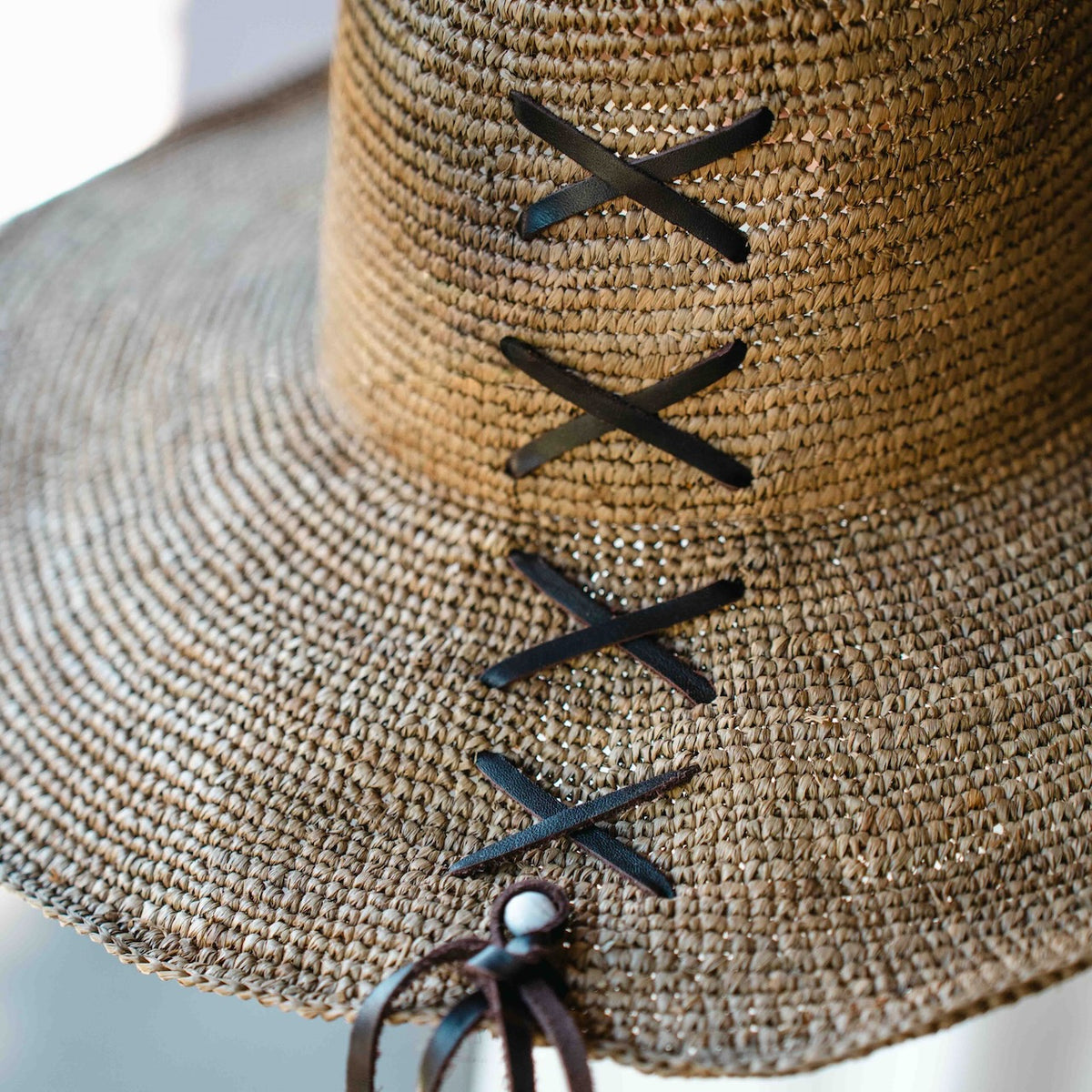 Made in Mada Aziz Lace gardening hat, handwoven from natural raffia with delicate lace-style detailing and a wide brim, available at Brookfield Gardens.