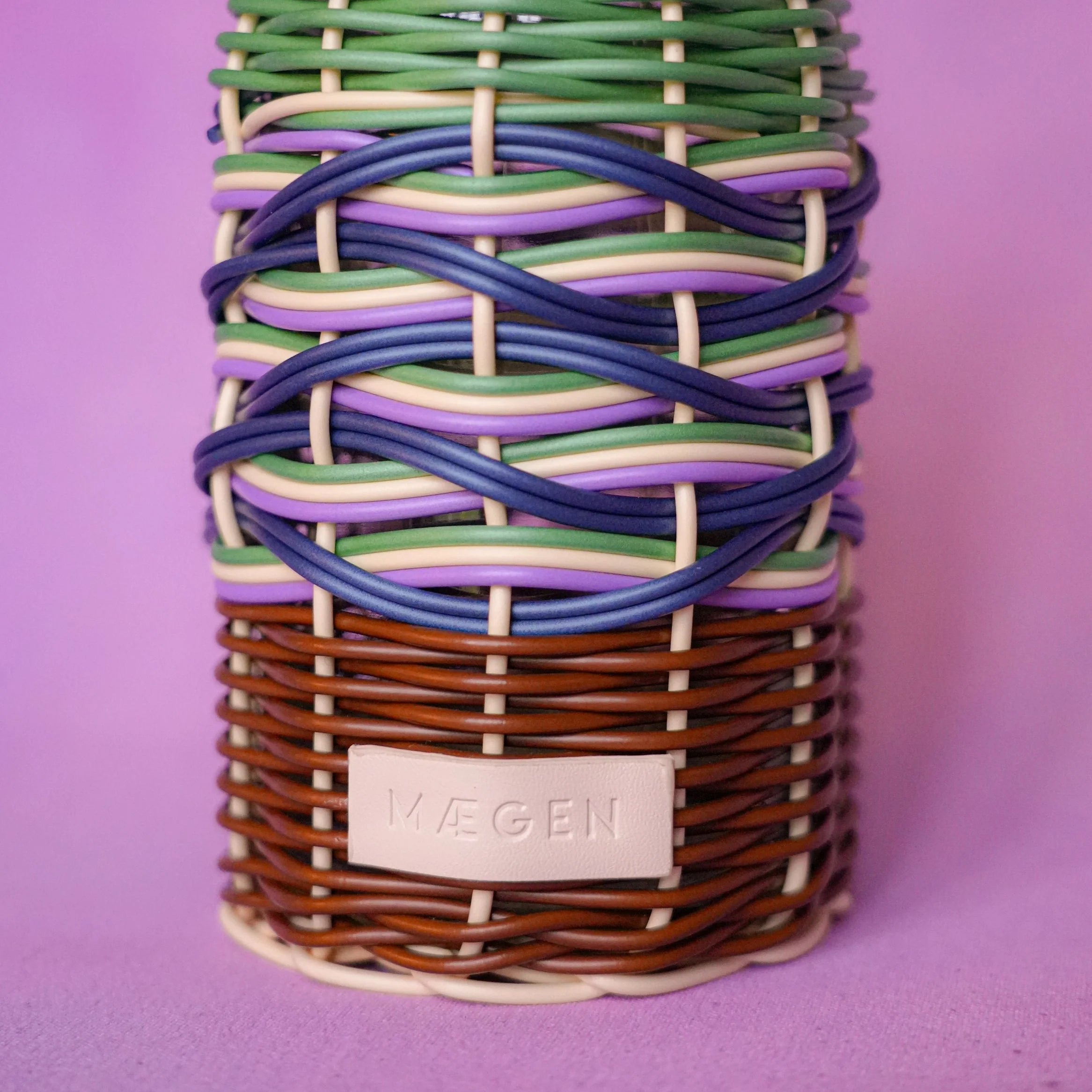 Maegen hand-woven oil pourer in navy with multicolour accents, faux rattan texture and stainless steel spout