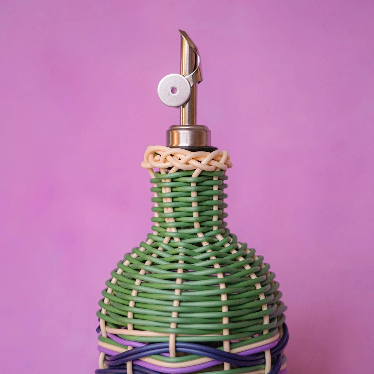 Maegen hand-woven oil pourer in navy with multicolour accents, faux rattan texture and stainless steel spout