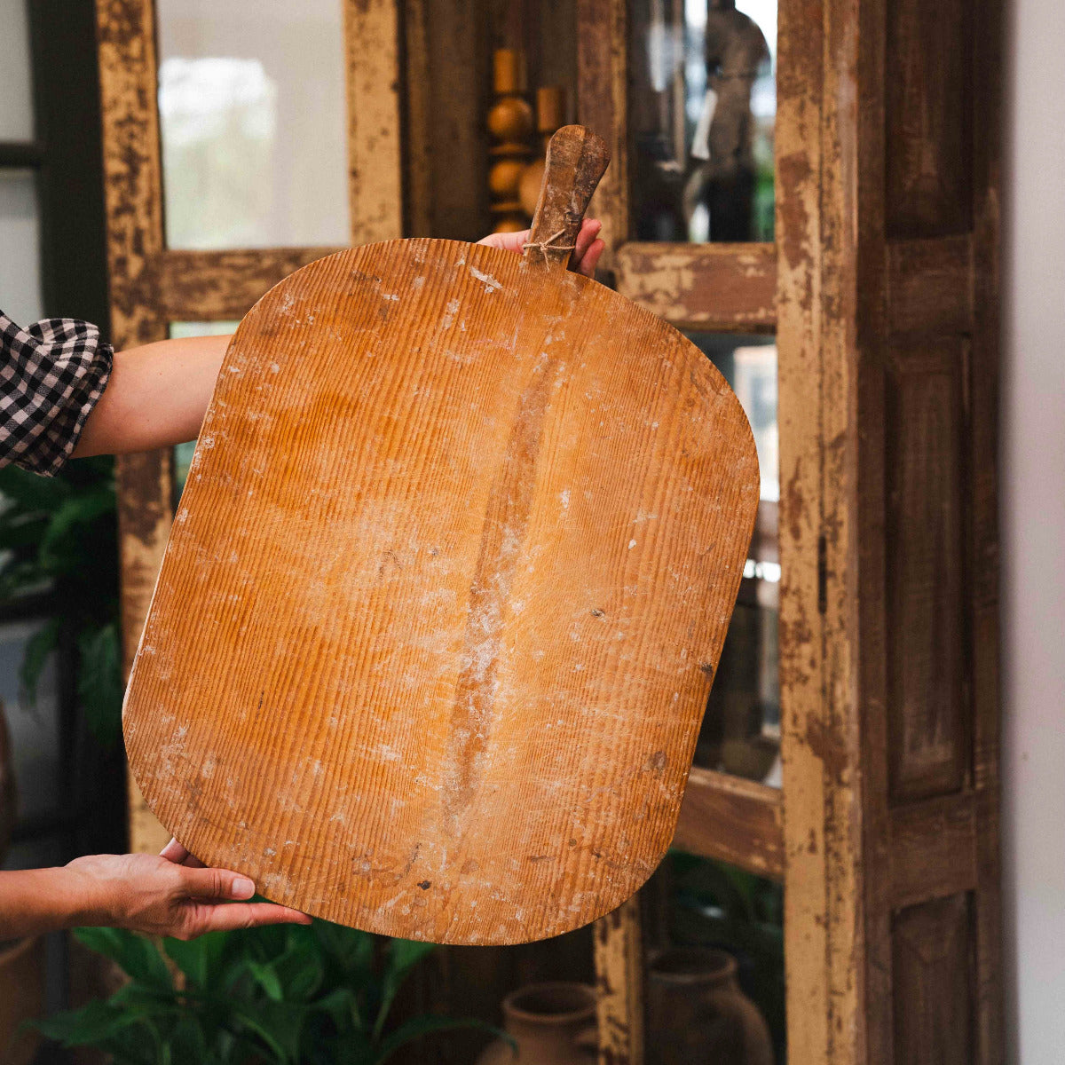 Old Turkish rectangular wooden bread board with handle and aged natural timber grain.