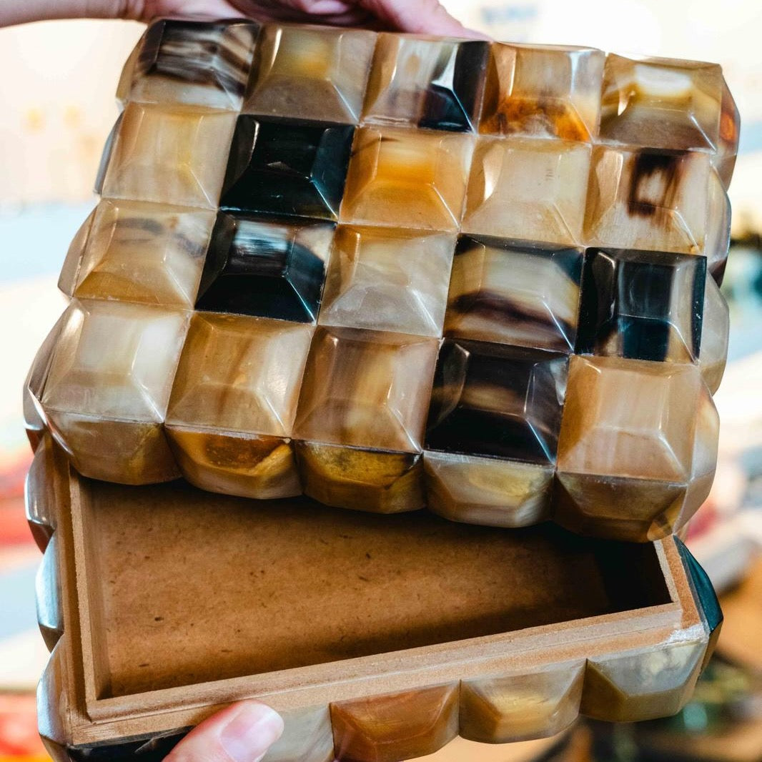 Prism horn box with faceted geometric design in warm caramel, ivory and tobacco tones, handcrafted decorative storage box with lid