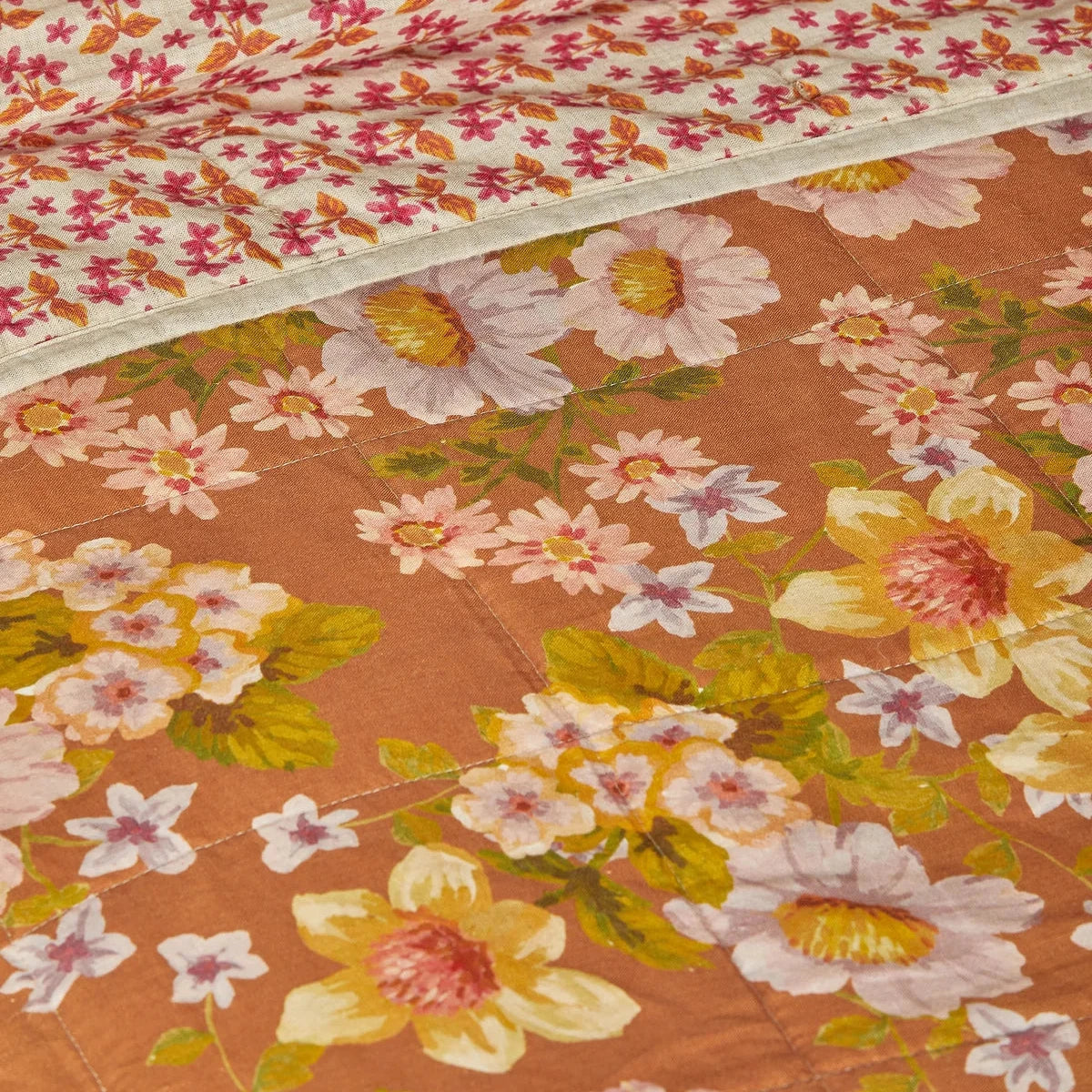 Bonnie & Neil Buttercup Rust & Petit Madeline Pink reversible linen quilted throw featuring warm rust florals and delicate pink botanical patterns.