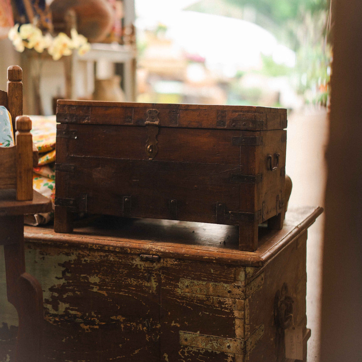Vintage wooden trunk on a rustic wooden surface with a blurred background