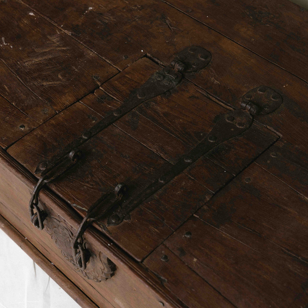 Vintage Indian wooden coffee table with lock, carved floral detail, iron hardware and hidden storage, exclusive to Brookfield Gardens Brisbane.