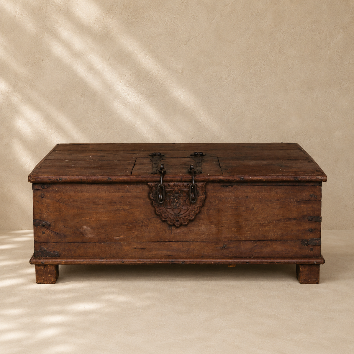 Vintage Indian wooden coffee table with lock, carved floral detail, iron hardware and hidden storage, exclusive to Brookfield Gardens Brisbane.