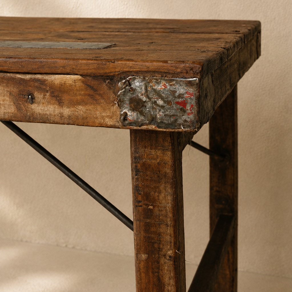 Long Indian wooden table with folding legs, aged timber top and rustic metal detailing, exclusive to Brookfield Gardens.