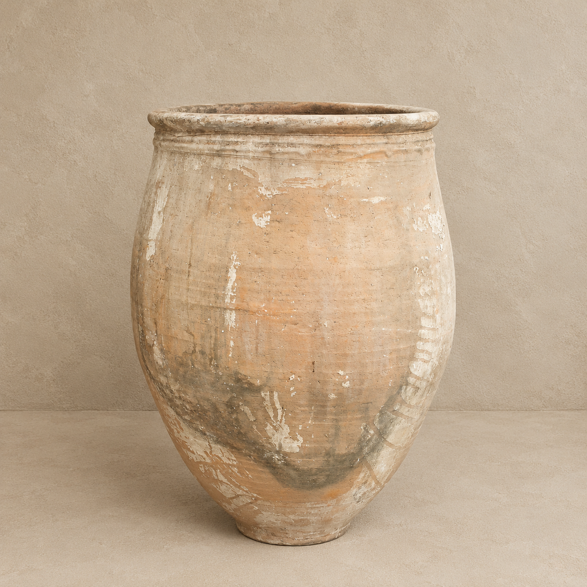 Large Ancient Turkish terracotta pot with rounded body, rolled rim and naturally weathered cream, earthy and grey patina, at Brookfield Gardens Brisbane.