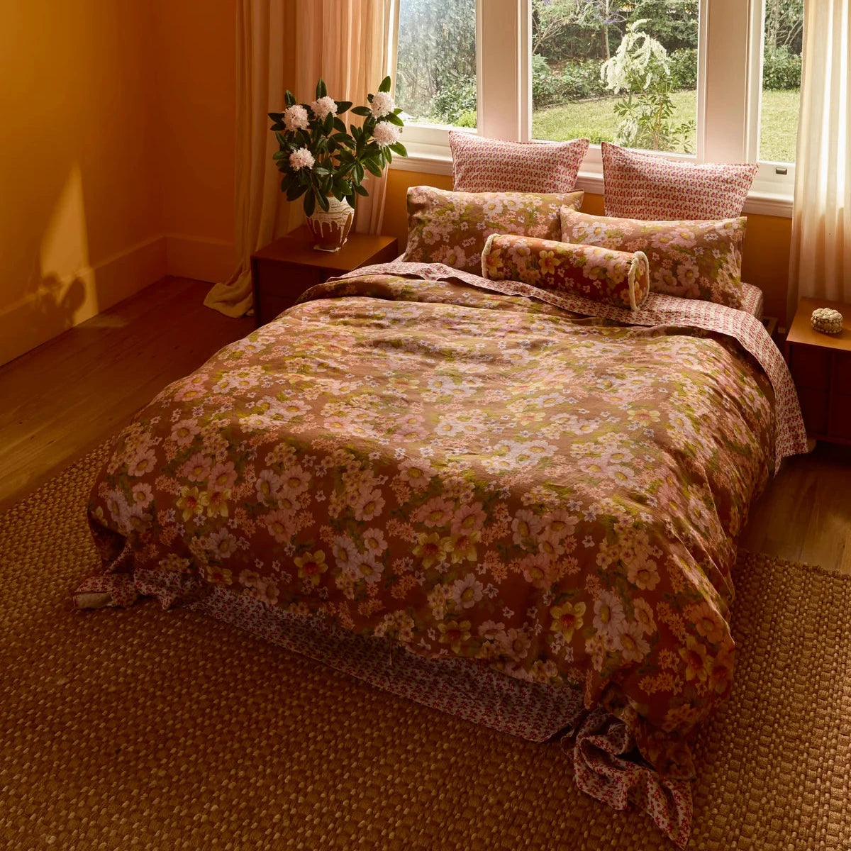 Bonnie & Neil Buttercup Rust standard linen pillowcases featuring colourful buttercup floral artwork on a warm rust background, set of two.