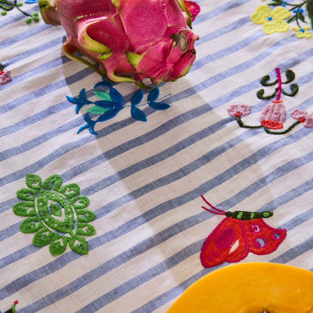 Kip & Co x Anna Spiro Malabar Floral Embroidered Tablecloth in Warm Floral Breeze, featuring decorative floral embroidery on a linen cotton blend.