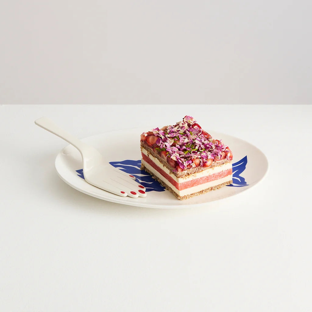 Maison Balzac ivory glazed ceramic hand-shaped cake server with glossy red fingernails.