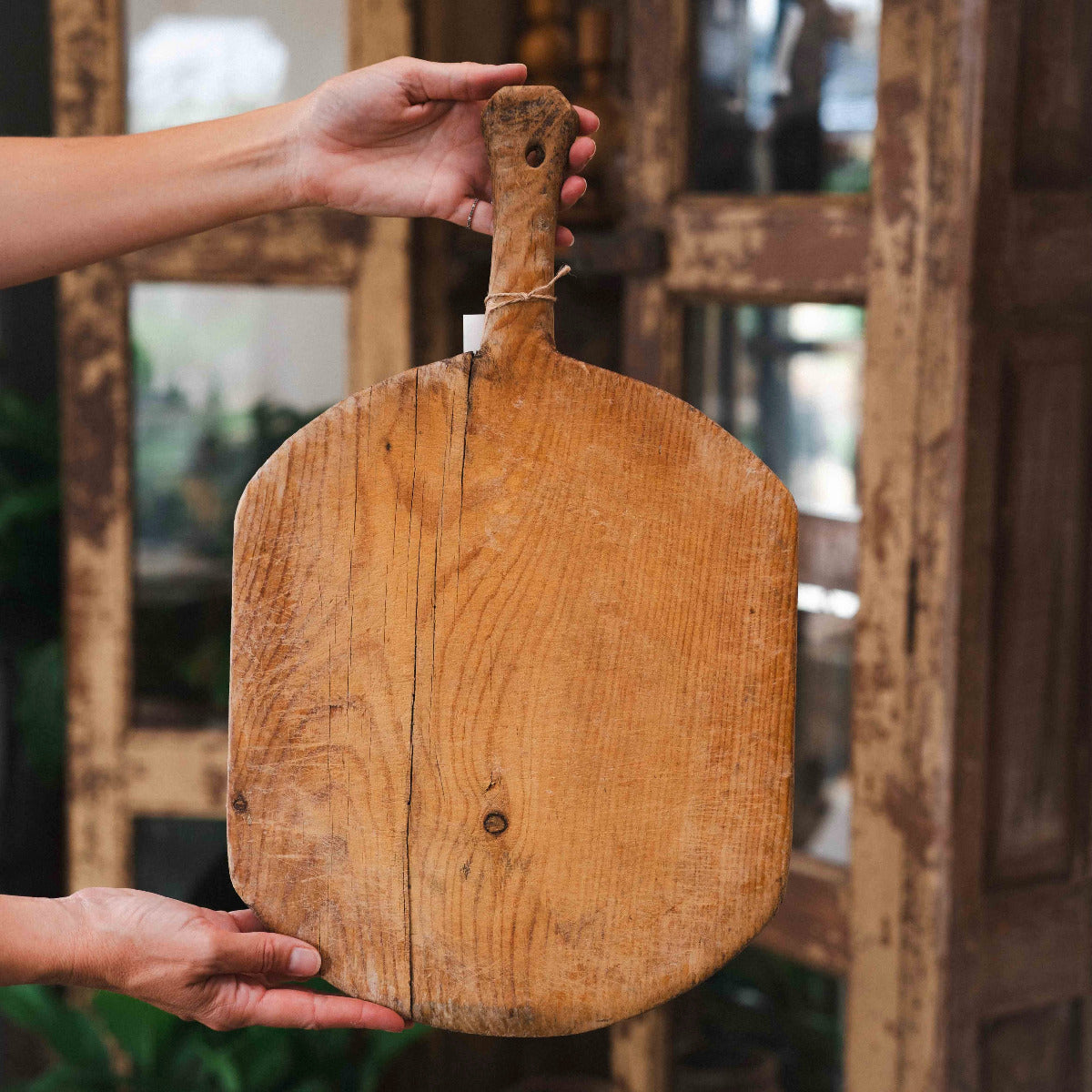 Old Vintage Turkish rectangular wooden bread board with handle and aged natural timber grain.