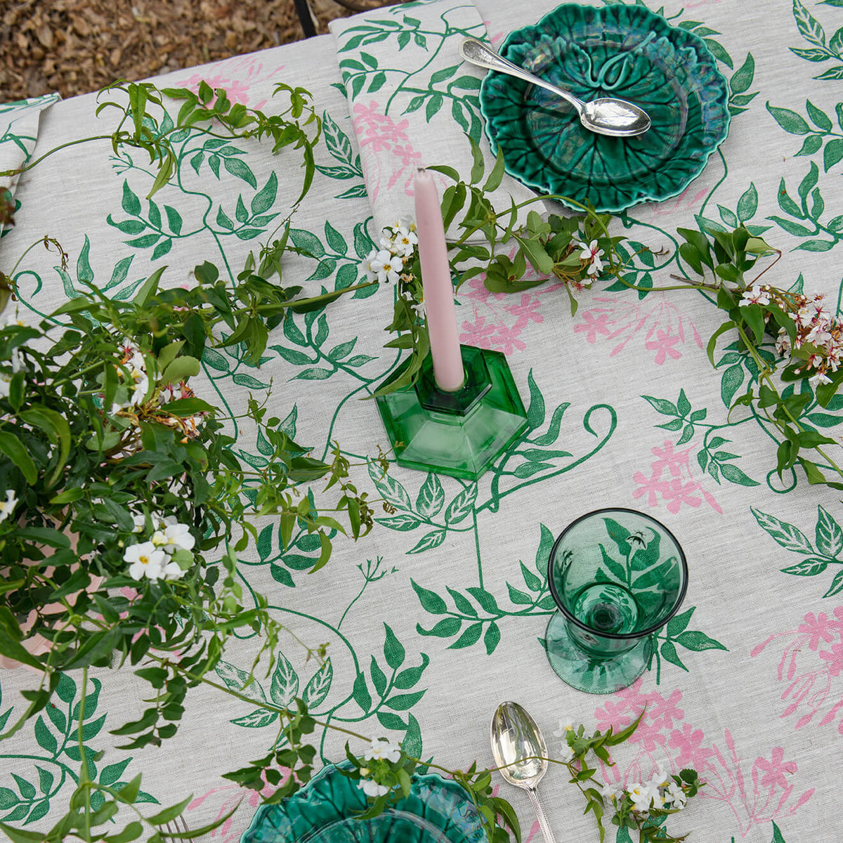Aqua Door Designs Jasmine linen tablecloth featuring hand screen printed green and pink botanical vines on natural linen, available at Brookfield Gardens Brisbane.