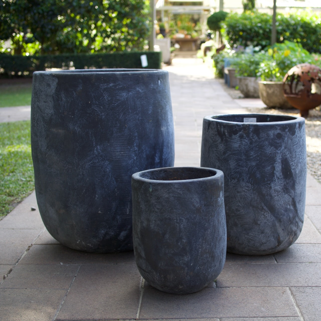 Rustica Black U Planters in multiple sizes with a textured charcoal finish, displayed as contemporary feature pots at Brookfield Gardens, Brisbane.