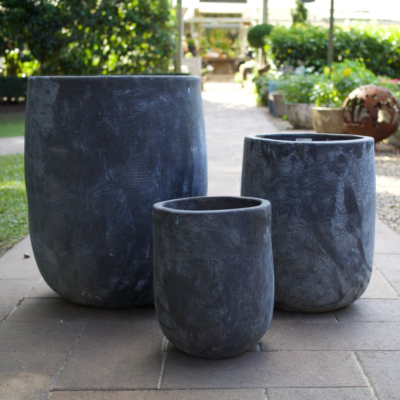 Rustica Black U Planters in multiple sizes with a textured charcoal finish, displayed as contemporary feature pots at Brookfield Gardens, Brisbane.