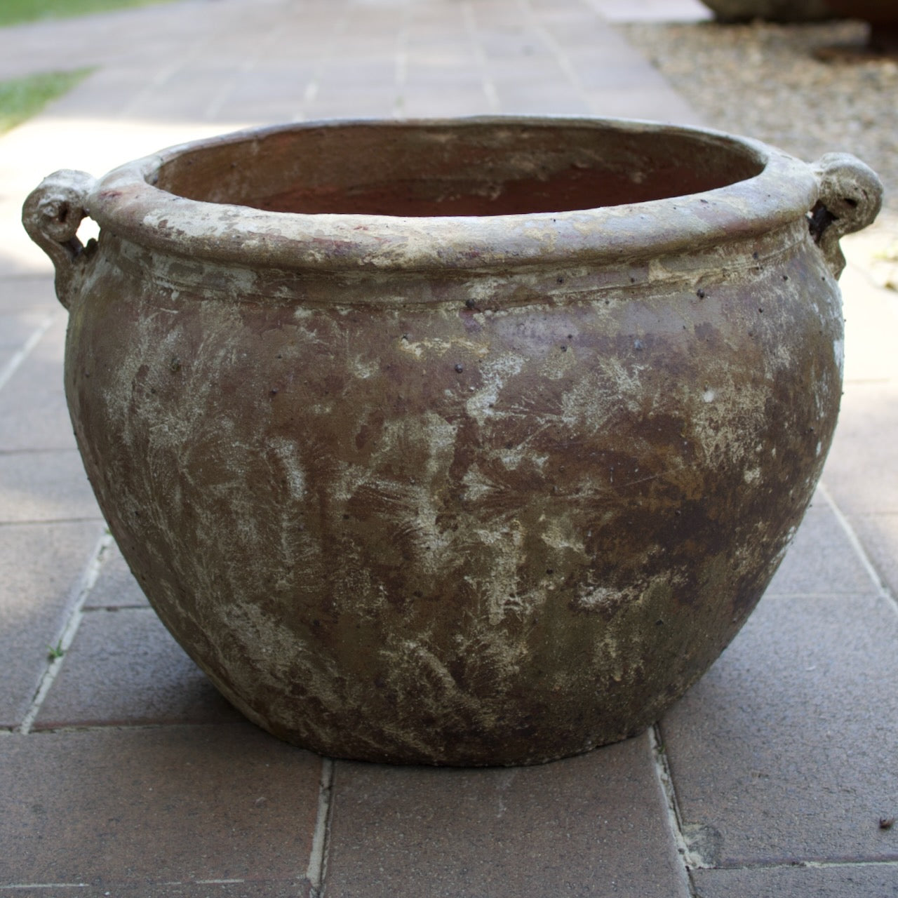 Rustica Rolled Handles Pots in two sizes with a weathered antique finish, displayed as Mediterranean-inspired feature pots at Brookfield Gardens, Brisbane.