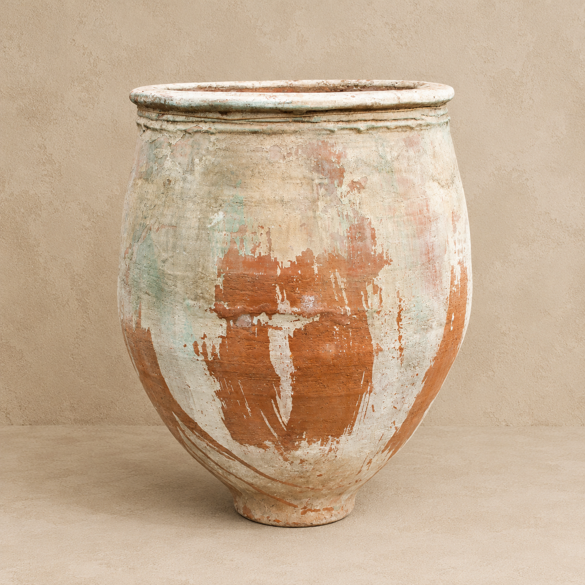 Ancient Turkish terracotta garden pot with rounded body, wide rolled rim and weathered white, orange and green-grey patina, Brookfield Gardens Brisbane.