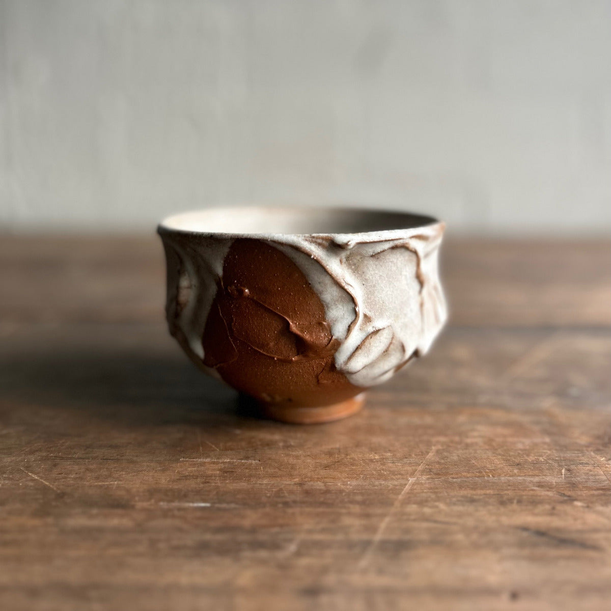 Ceramic bowl with marbled design on a wooden surface