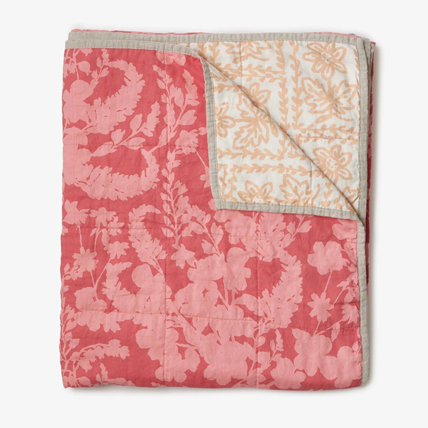 Bonnie and Neil Petal Pink & Daisy Buff linen quilted throw with reversible floral prints in soft pink and warm buff tones, crafted from stonewashed French flax linen.