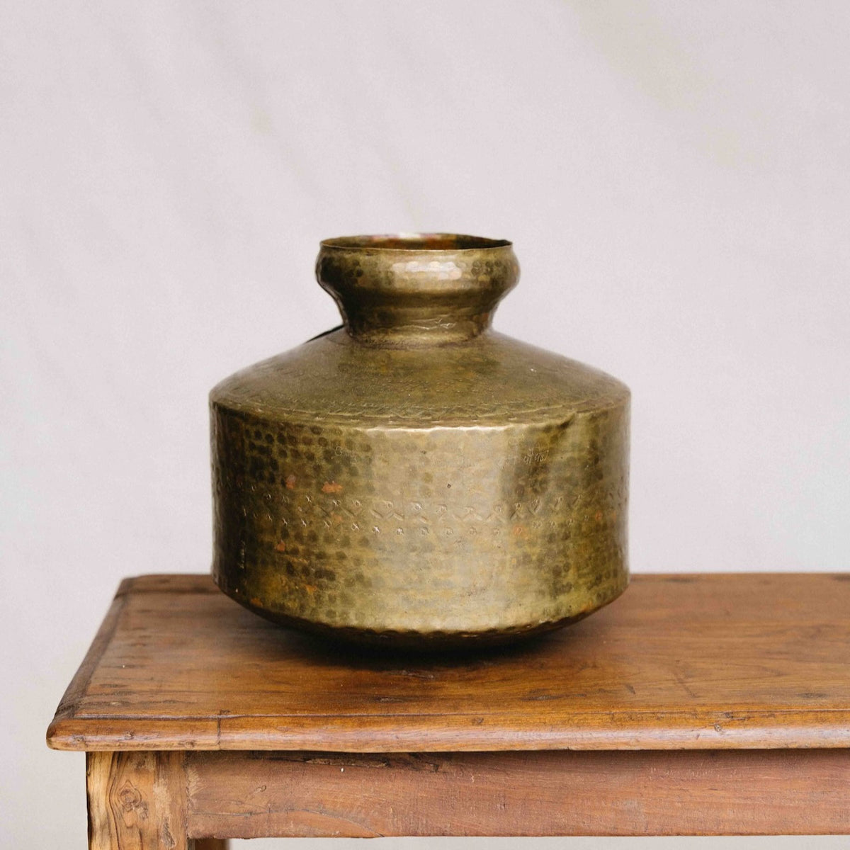 Vintage Indian brass mini vase, 22cm, featuring a rounded body, narrow neck, hammered detailing and aged golden patina, exclusive to Brookfield Gardens.