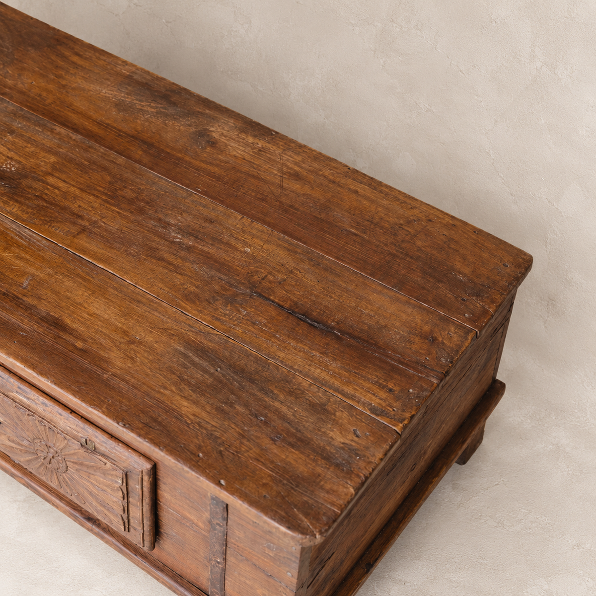 Vintage carved wooden coffee table from India with floral sunburst detailing and aged timber, 106 × 57 × 45cm, exclusive to Brookfield Gardens.
