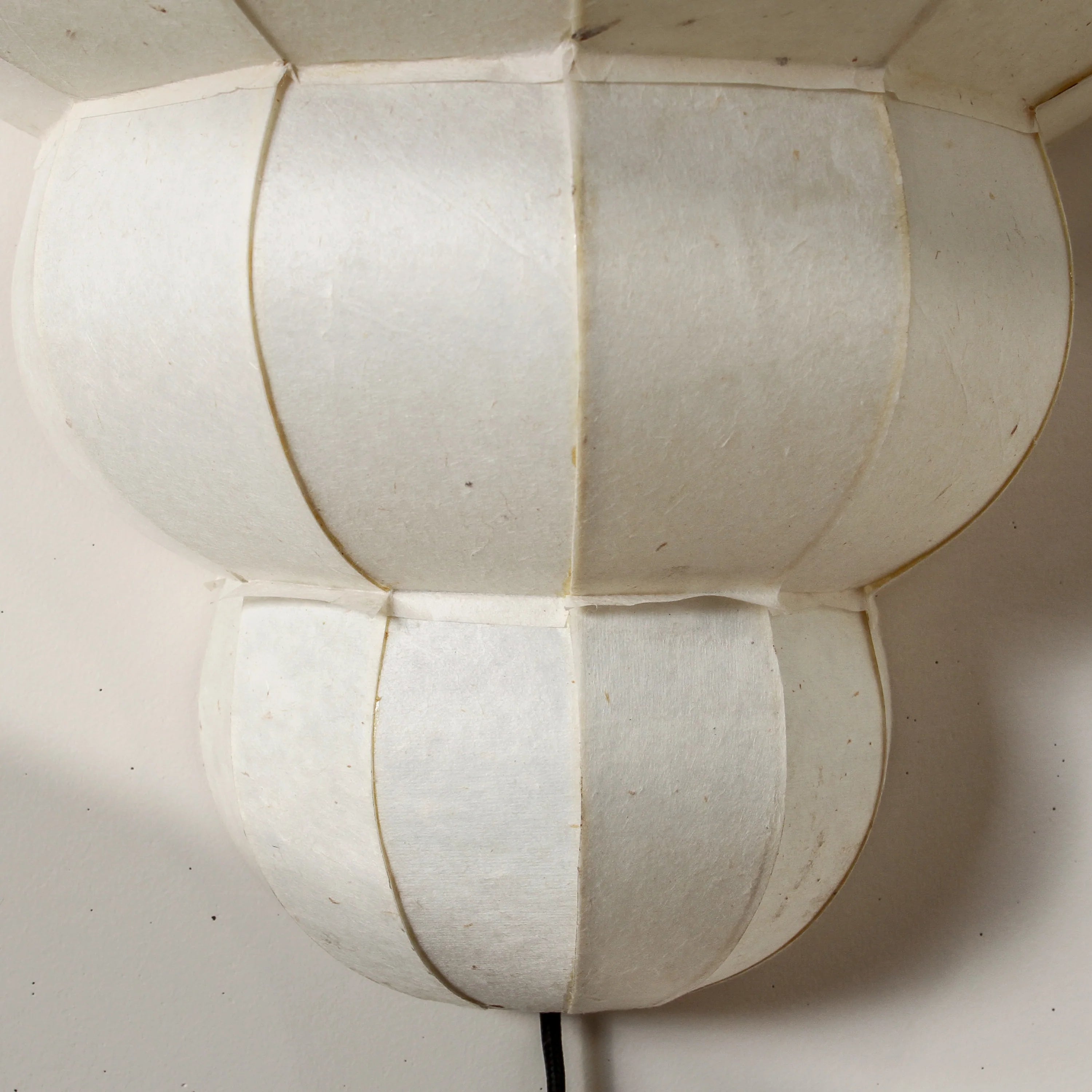 Clouded Wall Lamp with a softly diffused shade, creating warm ambient lighting in a contemporary interior.