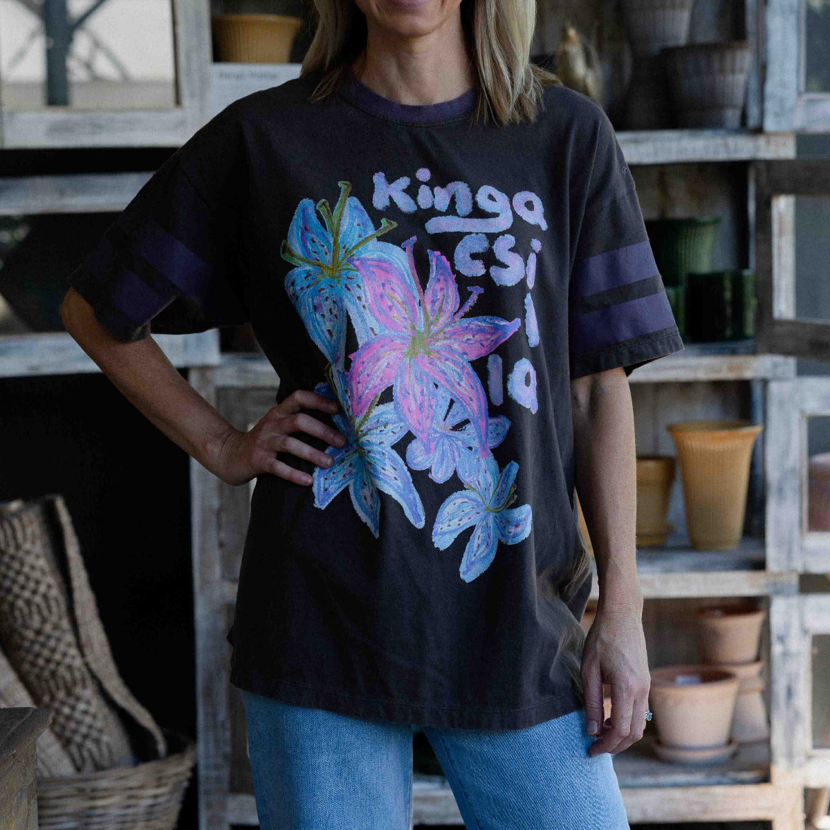 Kinga Csilla Hyper Lily OG Tee oversized cotton t-shirt in vintage black with hand-drawn lily graphic and sport stripe sleeve detail.