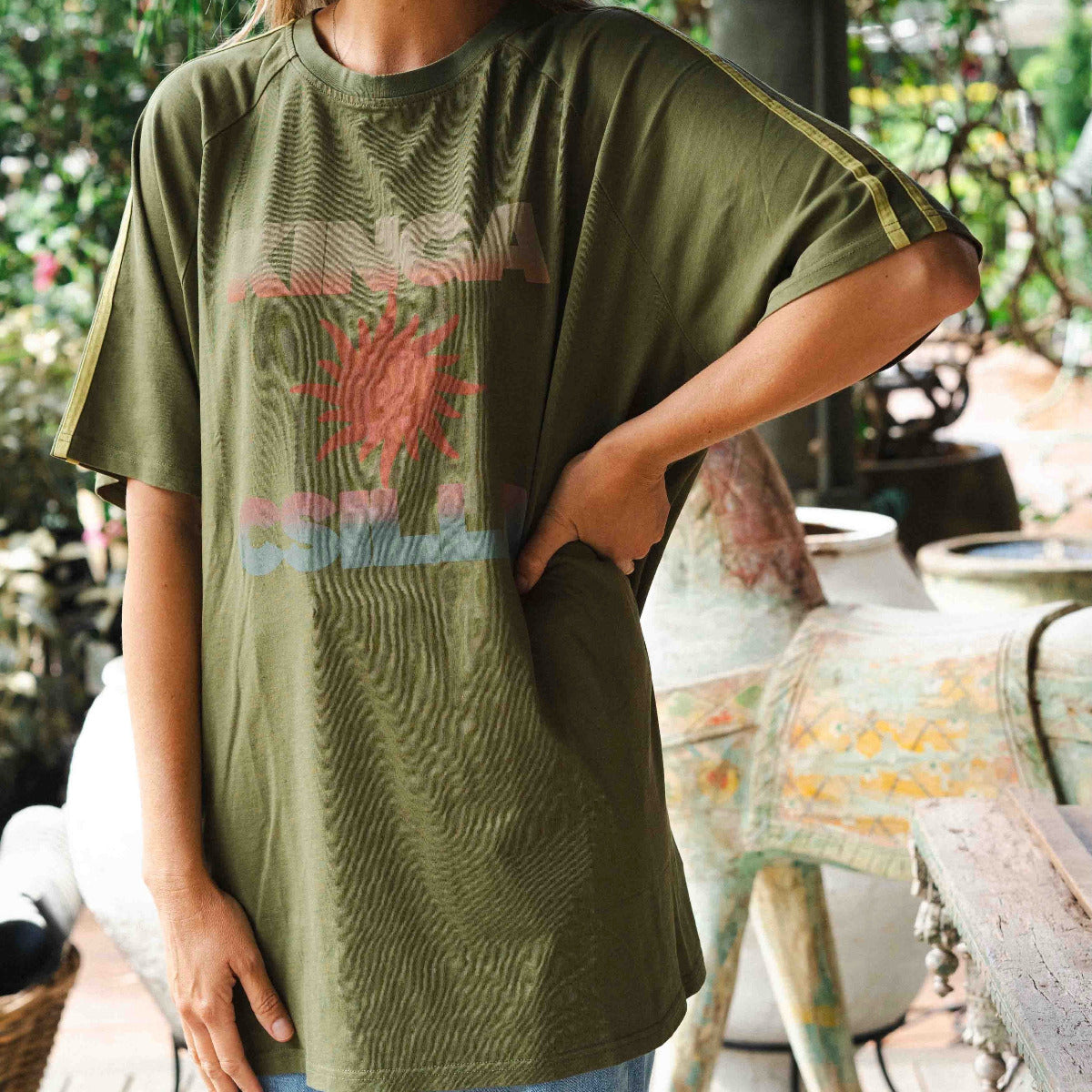 Kinga Csilla Sunset Tee in olive cotton with relaxed fit and faded coral sunset graphic