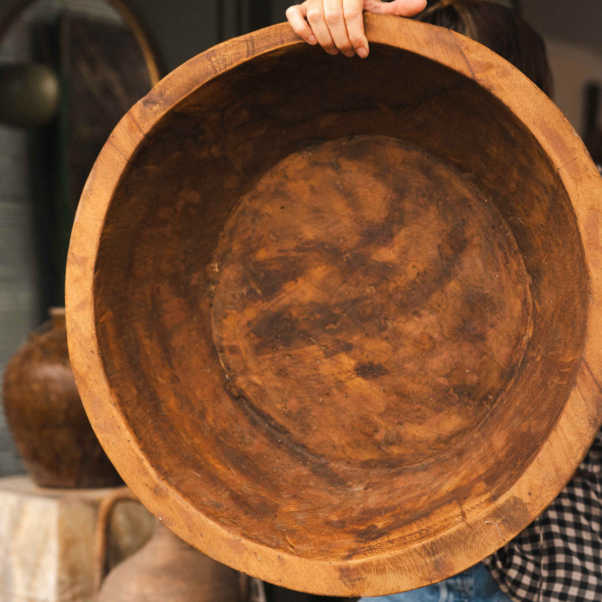 Large handcrafted Indian wooden bowl with natural timber grain and warm aged patina.