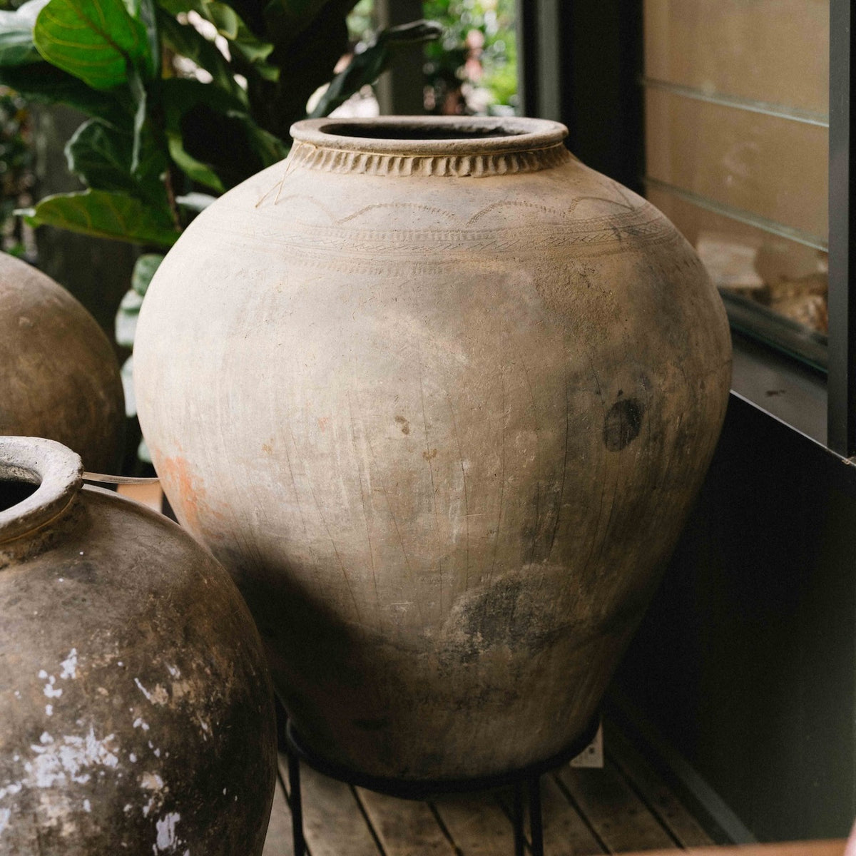 Large vintage Indian terracotta urn with rounded form, decorative rim and naturally weathered earthy finish, exclusive to Brookfield Gardens.