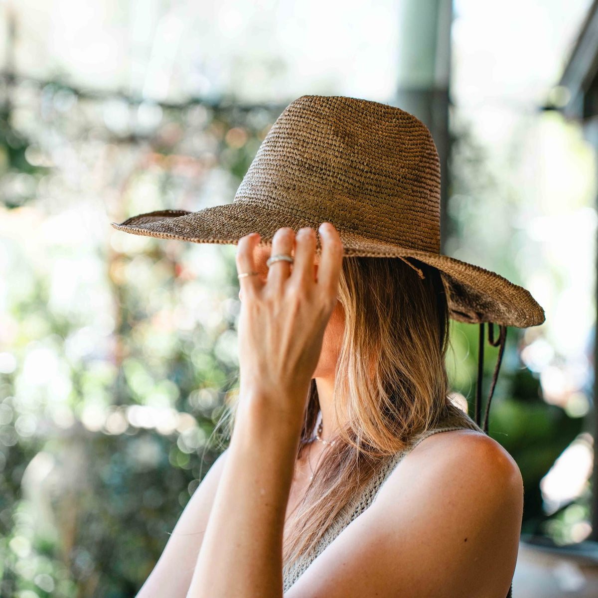 Made in Mada Aziz Lace gardening hat, handwoven from natural raffia with delicate lace-style detailing and a wide brim, available at Brookfield Gardens.