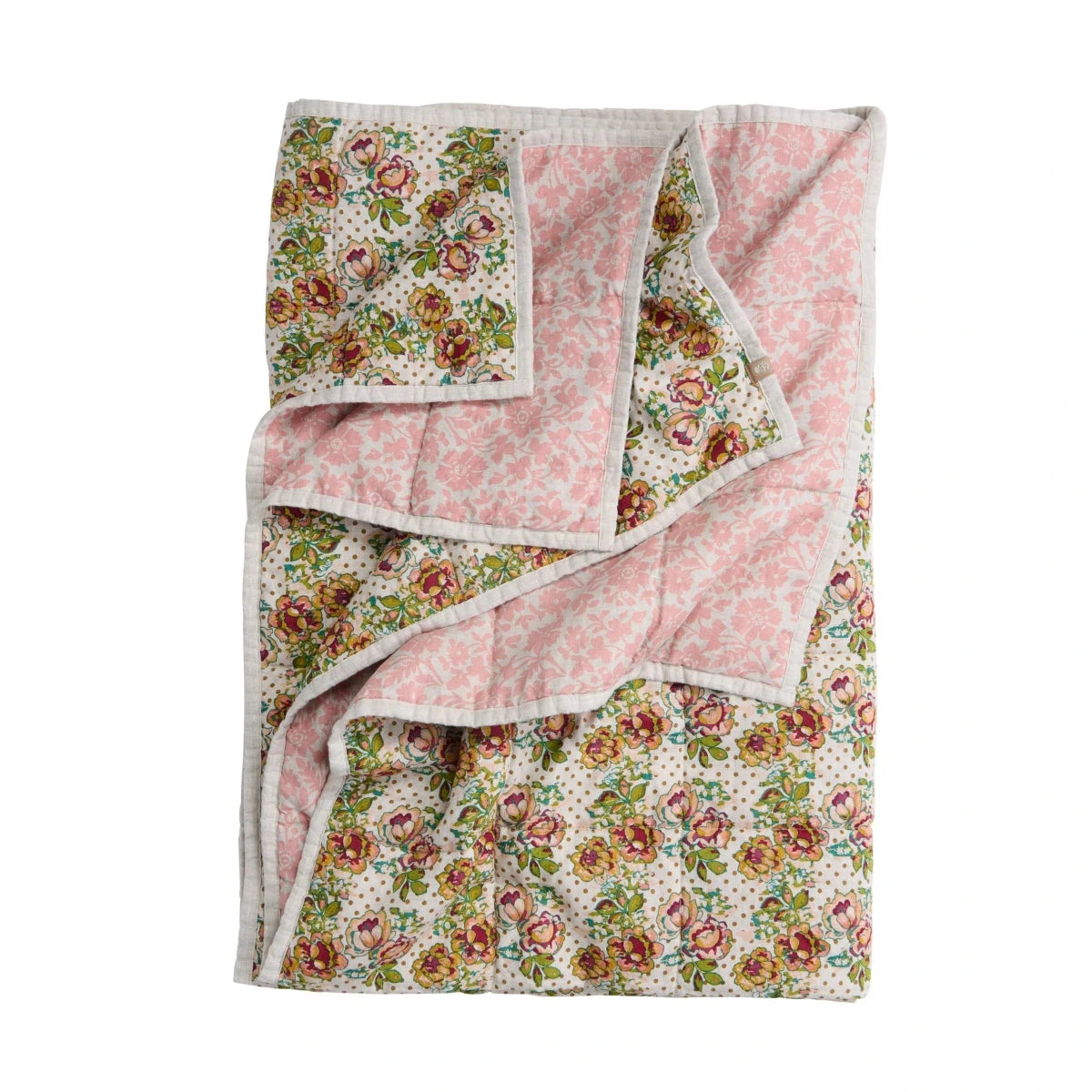 Floral quilt with pink border on a white background