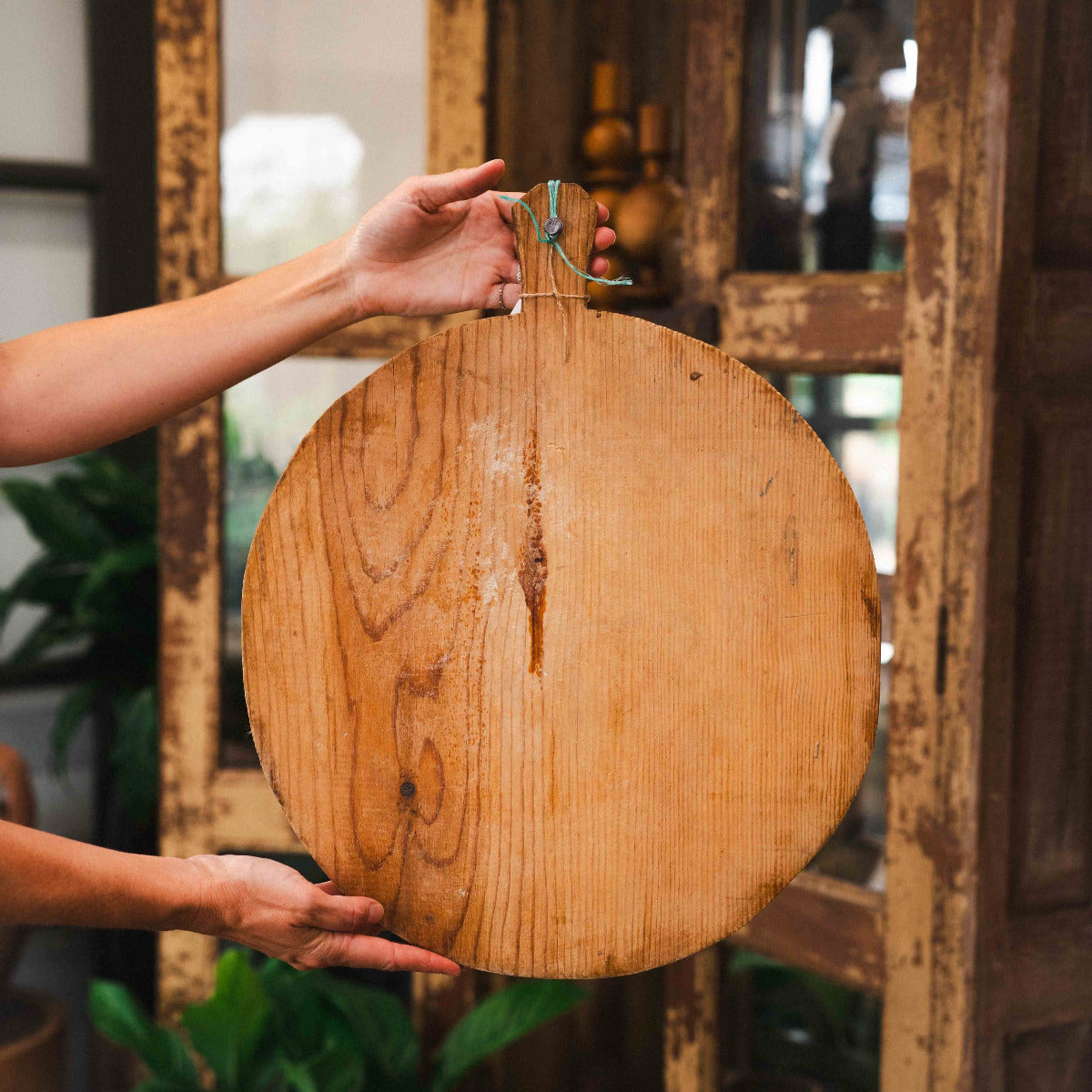 Authentic old Turkish round bread board 40cm with aged timber grain and natural patina. Available at Brookfield Gardens Brisbane.