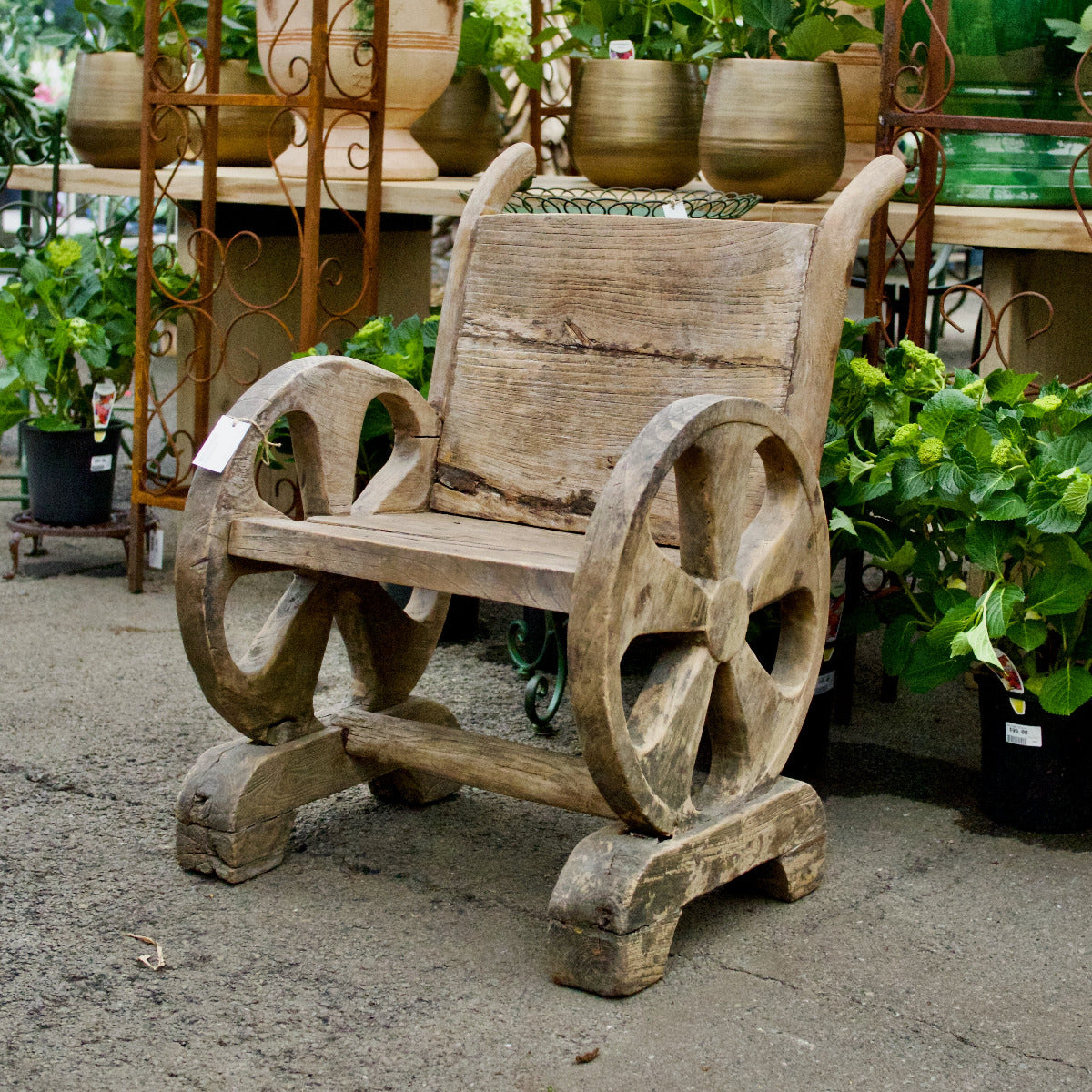 Wooden bench with large wheels in a garden setting