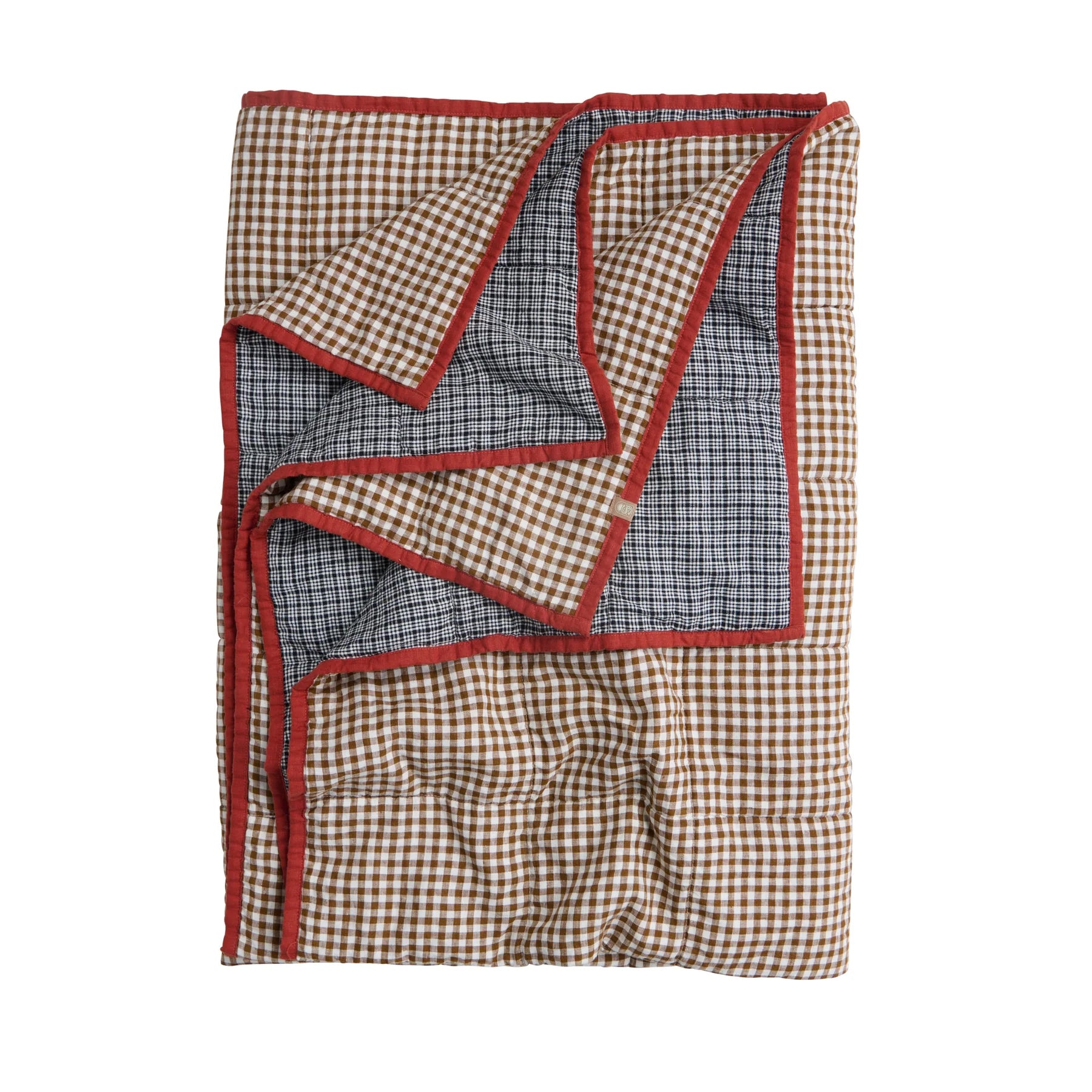 Folded checkered blanket with red border on a white background