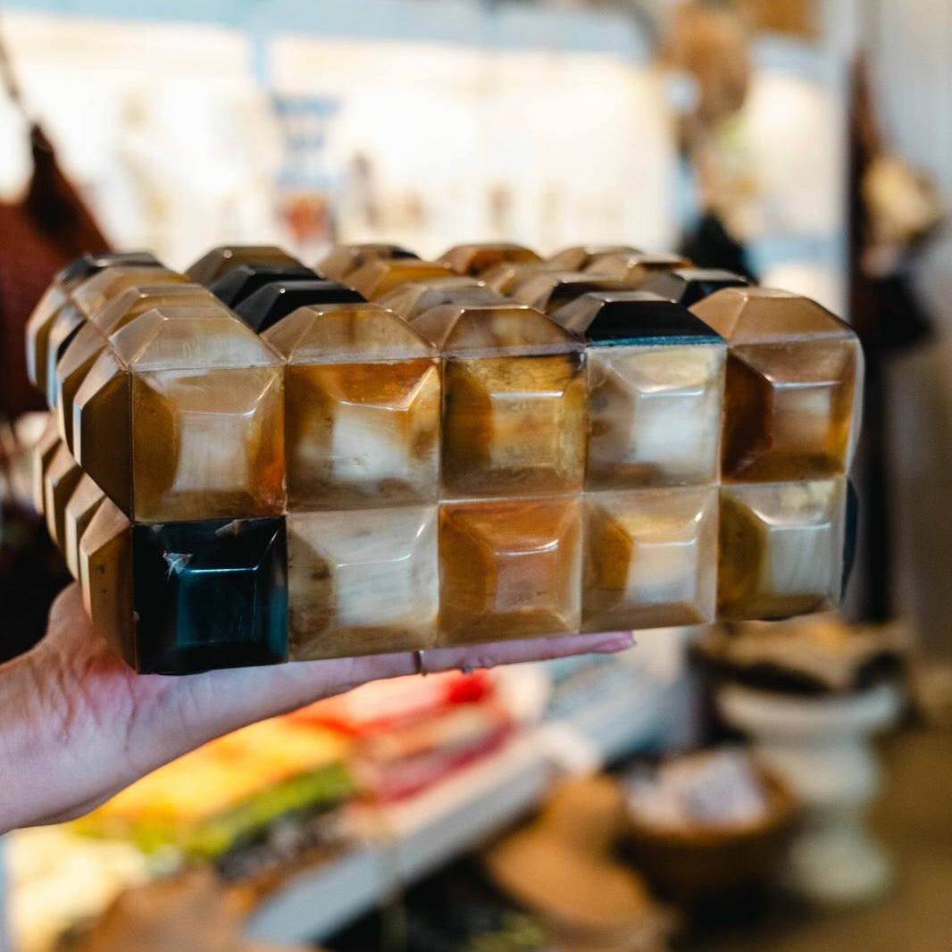 Prism horn box with faceted geometric design in warm caramel, ivory and tobacco tones, handcrafted decorative storage box with lid