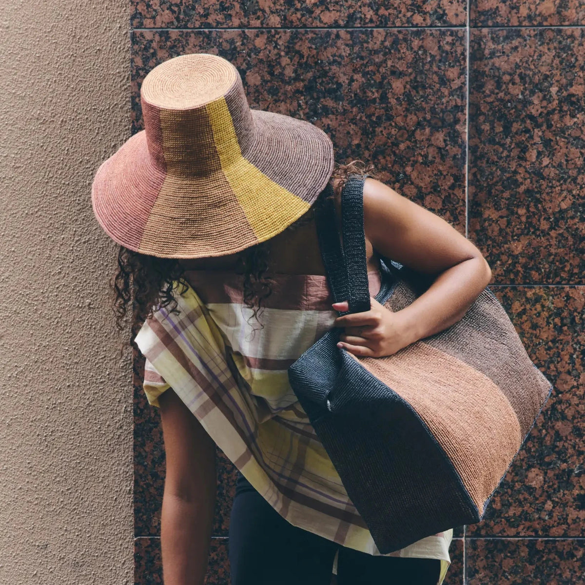 Tanora Rahel Sun handwoven raffia hat with terracotta sunburst design, natural earthy tones and wide wired brim, available at Brookfield Gardens.