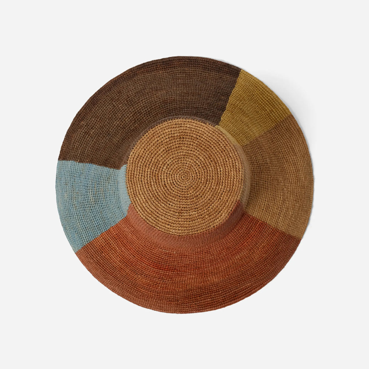 Tanora Rahel Sun handwoven raffia hat with terracotta sunburst design, natural earthy tones and wide wired brim, available at Brookfield Gardens.