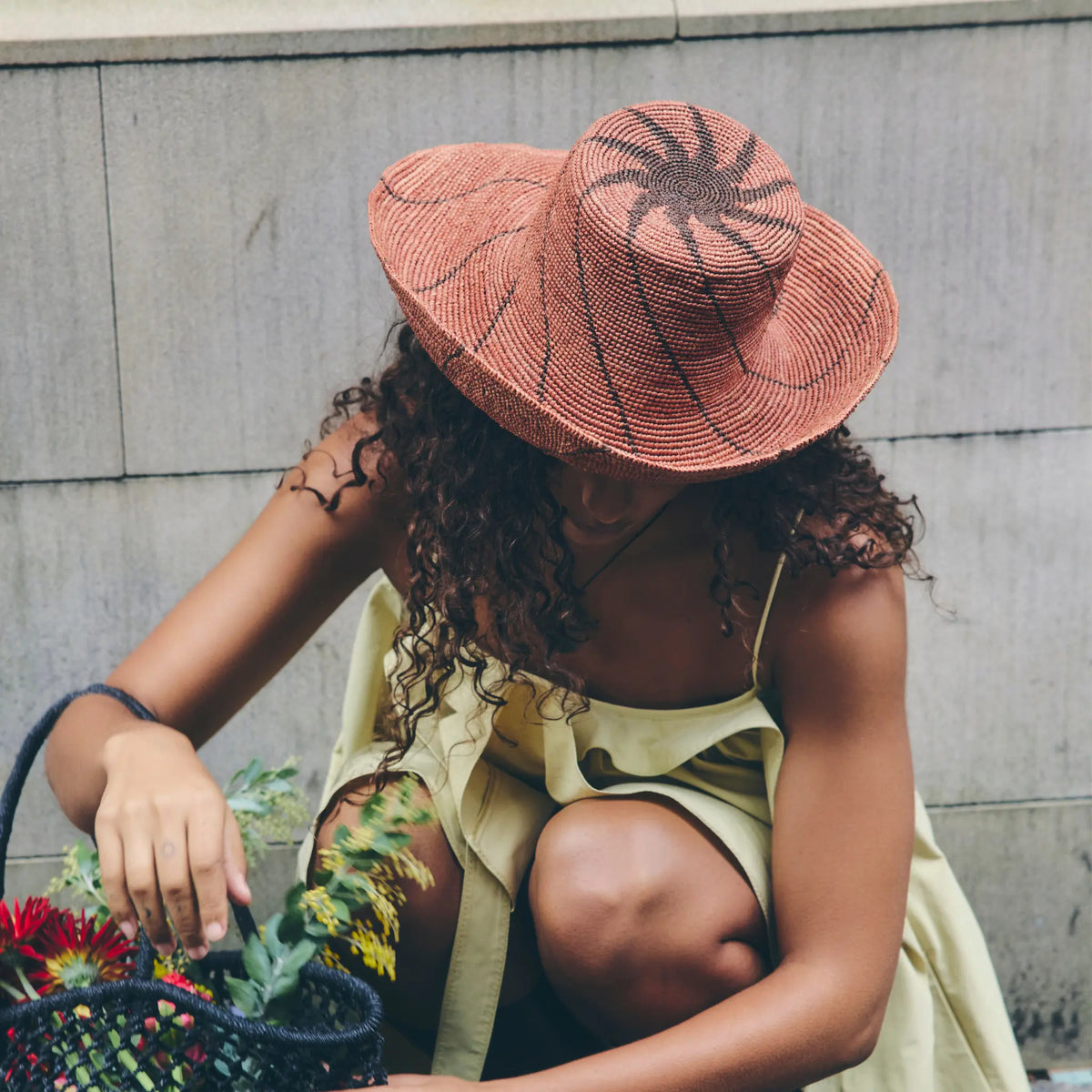 Tanora Rahel Horizon handwoven natural raffia hat featuring an earthy landscape-inspired pattern and wide wired brim, available at Brookfield Gardens.