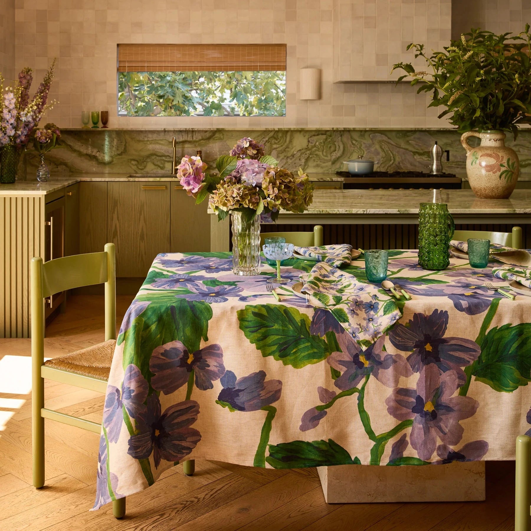 Bonnie and Neil Lilas Linen Tablecloth with soft lilac-blue florals and green foliage on oat linen.