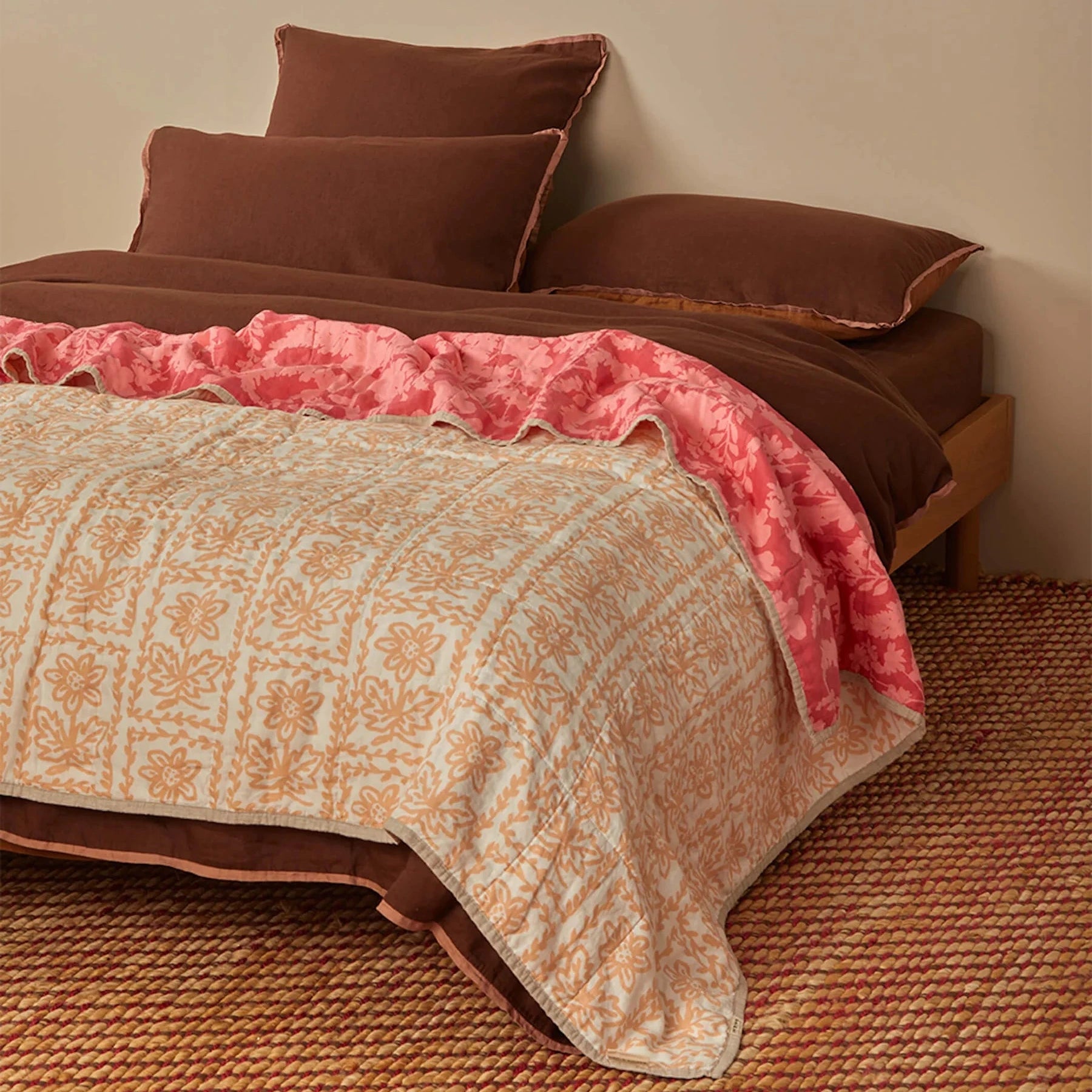 Bonnie and Neil Petal Pink & Daisy Buff linen quilted throw with reversible floral prints in soft pink and warm buff tones, crafted from stonewashed French flax linen.