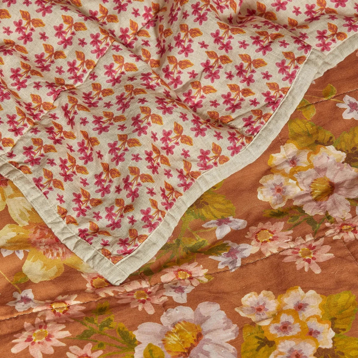 Bonnie & Neil Buttercup Rust & Petit Madeline Pink reversible linen quilted throw featuring warm rust florals and delicate pink botanical patterns.