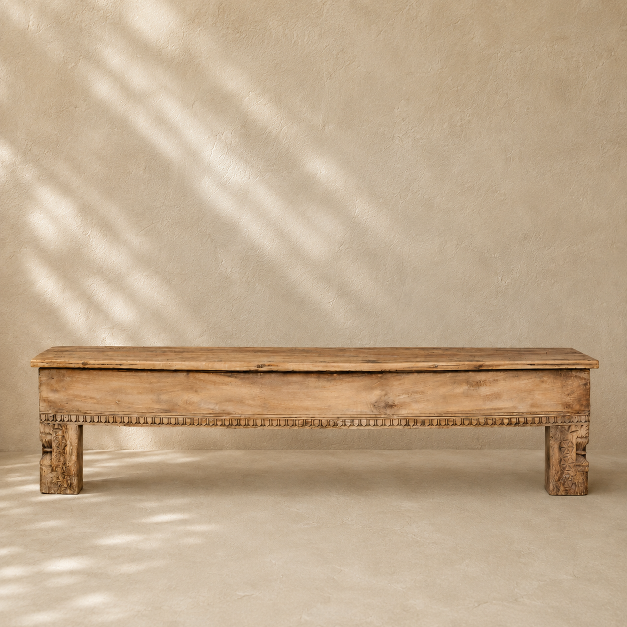 Vintage Indian wooden bench with scalloped top, hand-carved legs and decorative detailing in naturally aged timber.