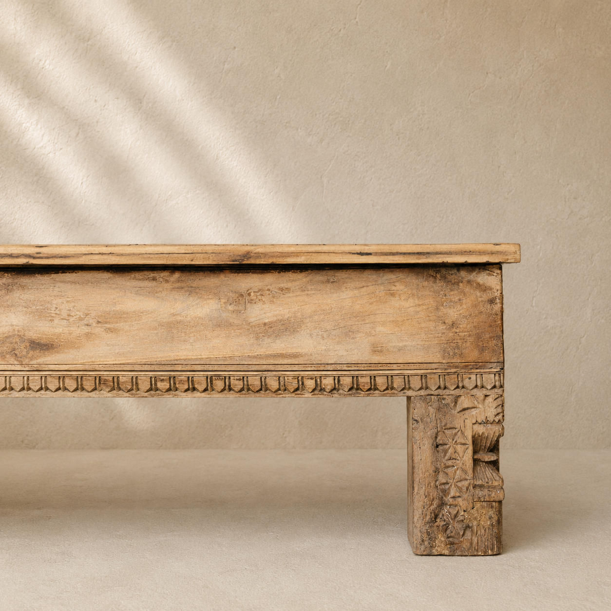 Vintage Indian wooden bench with scalloped top, hand-carved legs and decorative detailing in naturally aged timber.