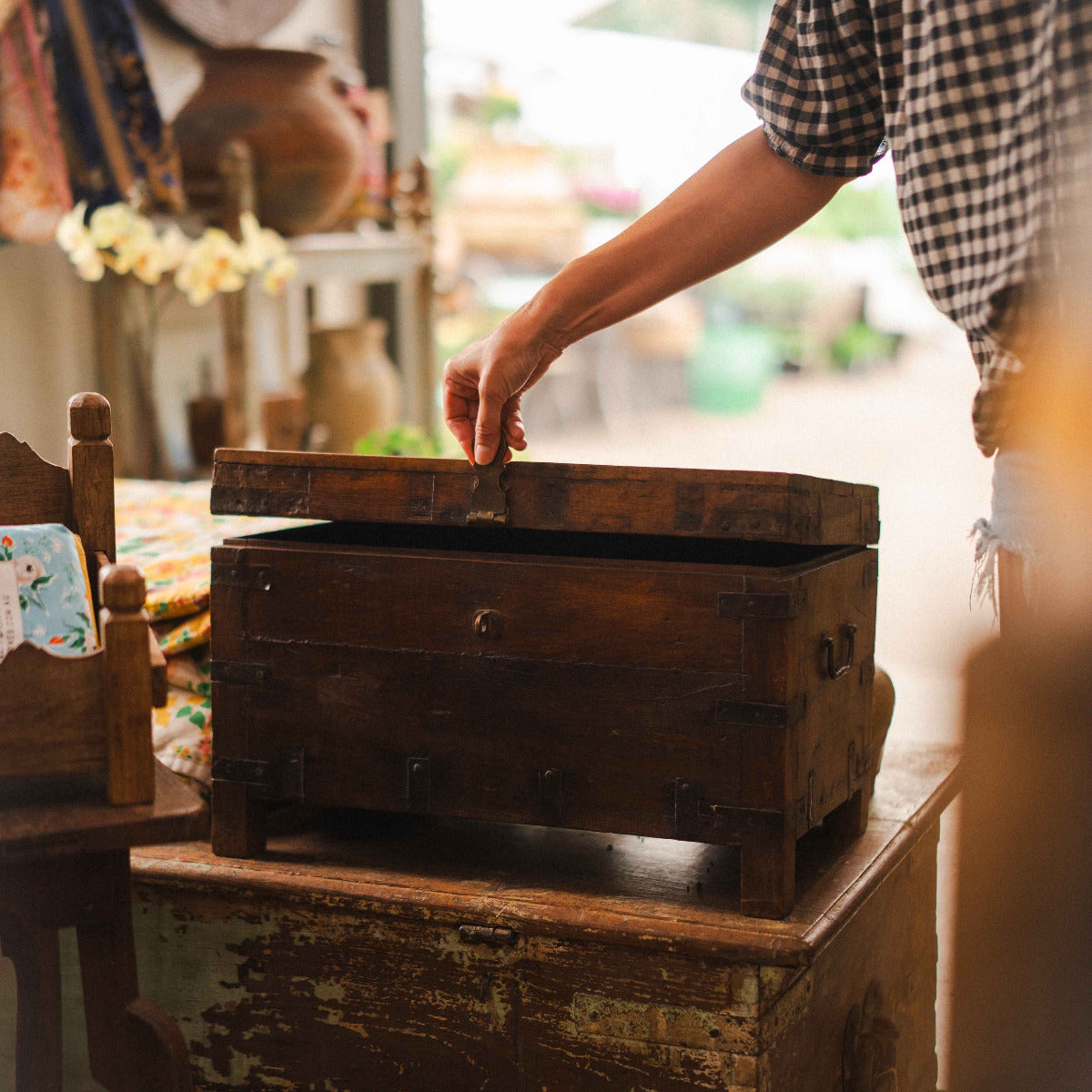 Vintage wooden iron storage chest with rustic hardwood finish and hand forged iron hardware.