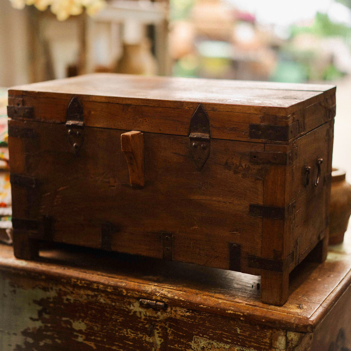 Vintage wooden trunk on a rustic surface with a blurred background